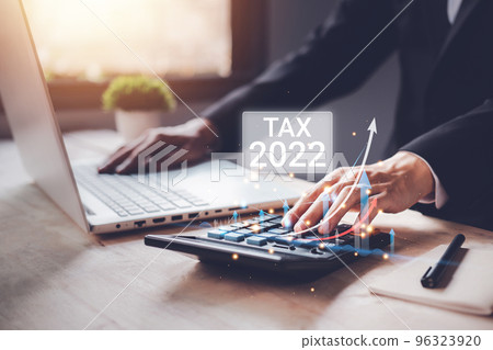 Tax 2022 of Individual income paid and corporations concept. Businessman using a calculator and laptop (notebook) of Data analysis, Paperwork, financial research, and report. 96323920