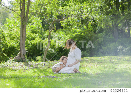 A pregnant mom and her 2-year-old daughter 96324531
