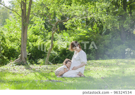 A pregnant mom and her 2-year-old daughter 96324534