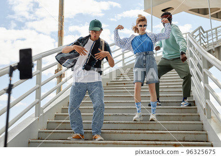 Young people dancing on stairs outdoors in urban area Young people dancing on stairs outdoors in urban area 96325675