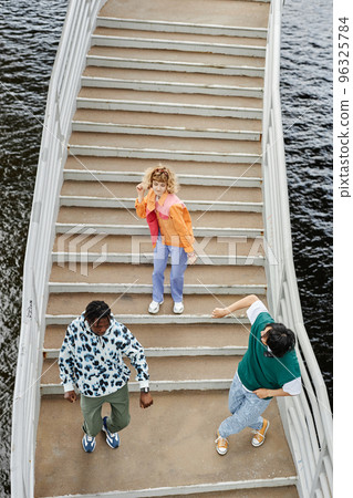 Group of young people dancing on stairs outdoors 96325784