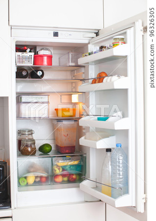 Open fridge in the kitchen. Open fridge in the kitchen. 96326305