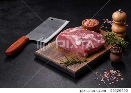 Fresh piece of raw pork with spices, salt and herbs on a wooden cutting board Fresh piece of raw pork with spices, salt and herbs on a wooden cutting board 96326490