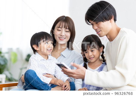 family looking at smartphone 96326768