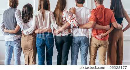 Group of young people hugging together Rear view 96328177