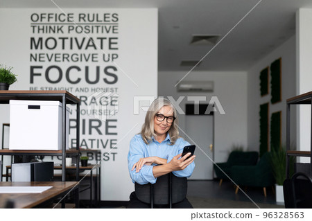woman accountant with a mobile phone in her hands in the office woman accountant with a mobile phone in her hands in the office 96328563