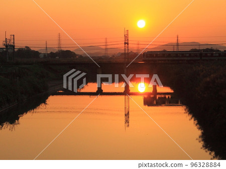Kintetsu Kashihara Line train crossing the iron bridge at dusk Kintetsu Kashihara Line train crossing the iron bridge at dusk 96328884
