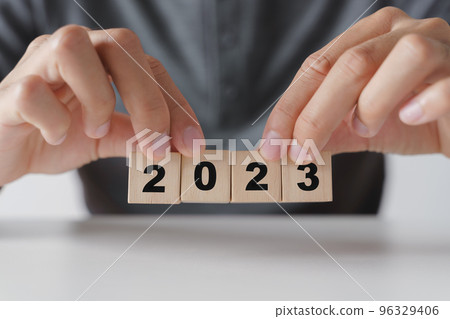 Man hand holding wooden cube block with 2023 year text . start to year 2023. happy new years concept. 96329406
