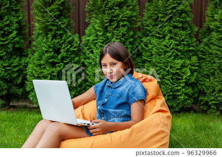 girl with a laptop in the garden 96329966