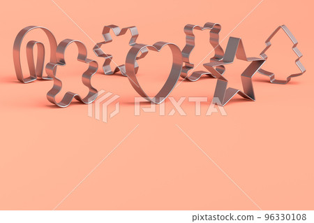 Set of metal cookie cutters for homemade Christmas biscuit on a coral background 96330108