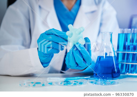 Female biotechnologist testing new chemical substances in a laboratory.. 96330870