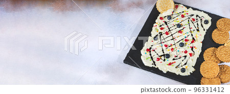 Sweet Butter board topped with chocolate, pomegranate seeds, blueberries. 96331412