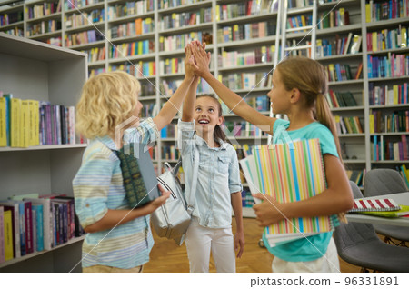 Group of cute kids in the library looking happy and enjoyed Group of cute kids in the library looking happy and enjoyed 96331891