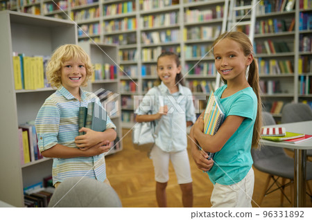 Group of cute kids in the library looking happy and enjoyed Group of cute kids in the library looking happy and enjoyed 96331892