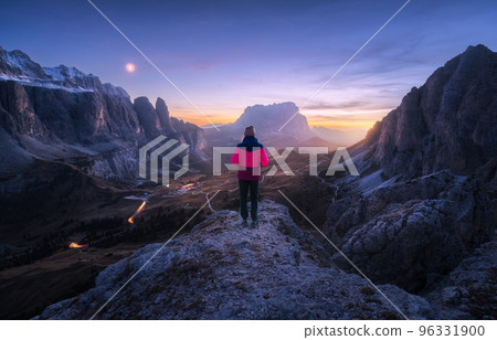 Woman on the rock and mountain peaks at night in autumn 96331900