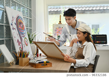 Shot of art students creating their artwork, working together in bright studio. Artistic and education concept Shot of art students creating their artwork, working together in bright studio. Artistic and education concept 96332186