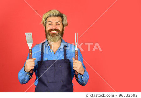 Bbq food. Cooking utensils. Summer picnic. Bbq american tradition. Culinary concept. Tools roasting meat. Man in apron hold barbecue grill. Hipster dyed beard promoting bbq equipment. Cooking healthy Bbq food. Cooking utensils. Summer picnic. Bbq american tradition. Culinary concept. Tools roasting meat. Man in apron hold barbecue grill. Hipster dyed beard promoting bbq equipment. Cooking healthy 96332592