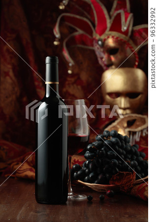 Red wine, grapes, and vintage carnival masks. Red wine, grapes, and vintage carnival masks. 96332992