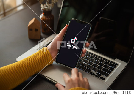 Closed up image of a Female using TikTok application on a smartphone in home.17 November, 2022. ChiangMai, Thailand. Closed up image of a Female using TikTok application on a smartphone in home.17 November, 2022. ChiangMai, Thailand. 96333118
