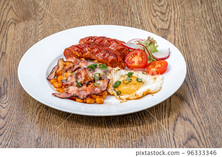 breakfast plate with sausage, bacon, egg and beans 96333346
