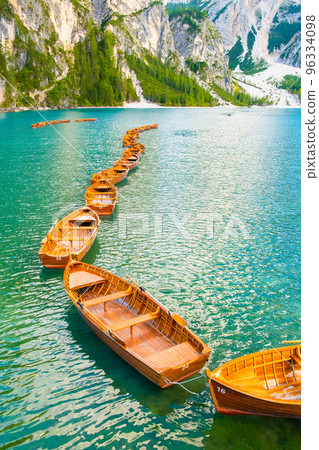 Group of the traditional rowing boats on Lake Braies with the picturesque Dolomites in the background. Group of the traditional rowing boats on Lake Braies with the picturesque Dolomites in the background. 96334098