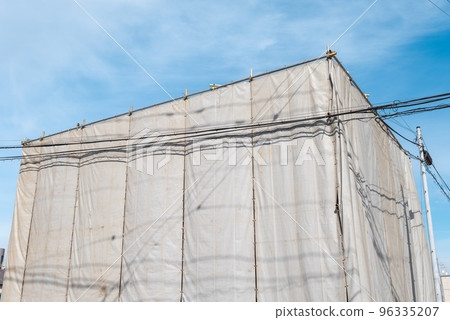 Blue sky and temporary enclosure for demolition work 96335207