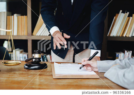 Discussing legal matters and signing important documents. 96336166