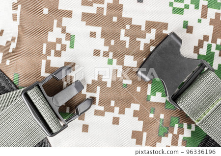 Plastic buckles on the backpack. Part of a khaki backpack. 96336196