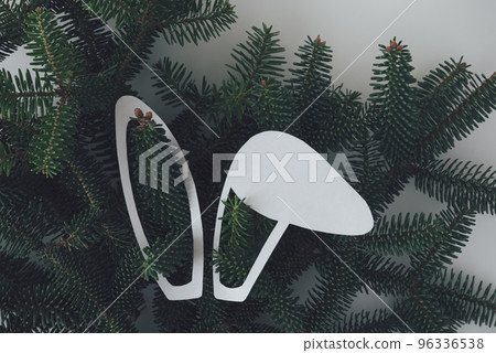 White rabbit ears on the background of a Christmas tree. 2023 new year of the rabbit according to the oriental calendar. White rabbit ears on the background of a Christmas tree. 2023 new year of the rabbit according to the oriental calendar. 96336538
