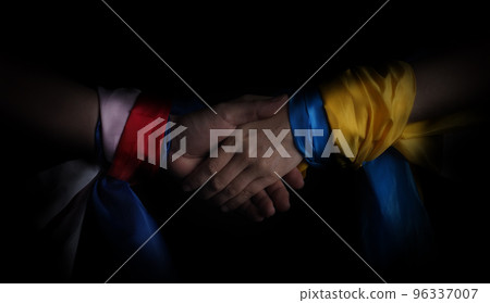 Russian flag and Ukrainian flag on a black background. Russian flag and Ukraine flag in hands showing symbol of struggle war political struggle political expressions Civil wars and territory conflict. Russian flag and Ukrainian flag on a black background. Russian flag and Ukraine flag in hands showing symbol of struggle war political struggle political expressions Civil wars and territory conflict. 96337007