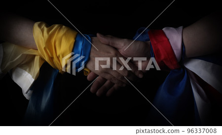 Russian flag and Ukrainian flag on a black background. Russian flag and Ukraine flag in hands showing symbol of struggle war political struggle political expressions Civil wars and territory conflict. 96337008