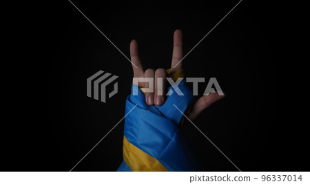 Russian flag and Ukrainian flag on a black background. Russian flag and Ukraine flag in hands showing symbol of struggle war political struggle political expressions Civil wars and territory conflict. 96337014