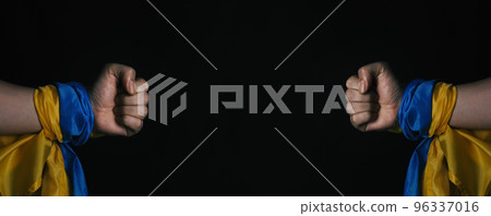 Russian flag and Ukrainian flag on a black background. Russian flag and Ukraine flag in hands showing symbol of struggle war political struggle political expressions Civil wars and territory conflict. 96337016