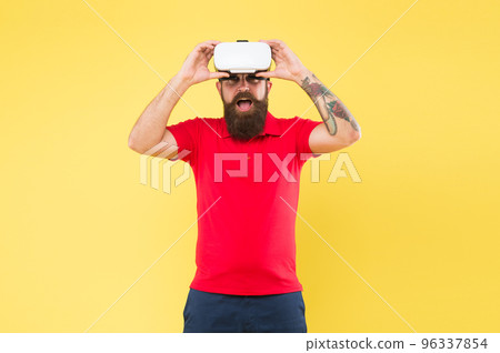 Impressive experience. Man play game in VR glasses. Hipster with virtual reality headset. Virtual communication concept. Virtual simulation. Virtual reality is like dreaming with your eyes open Impressive experience. Man play game in VR glasses. Hipster with virtual reality headset. Virtual communication concept. Virtual simulation. Virtual reality is like dreaming with your eyes open 96337854