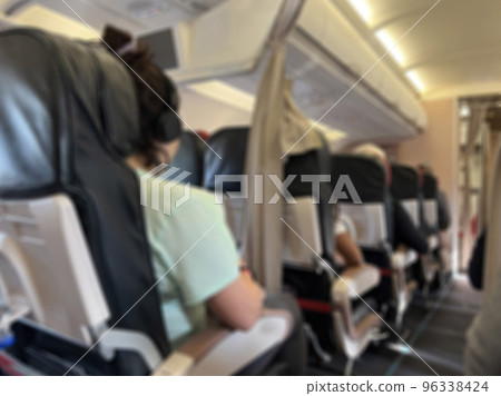 blurred interior of plane with passengers 96338424