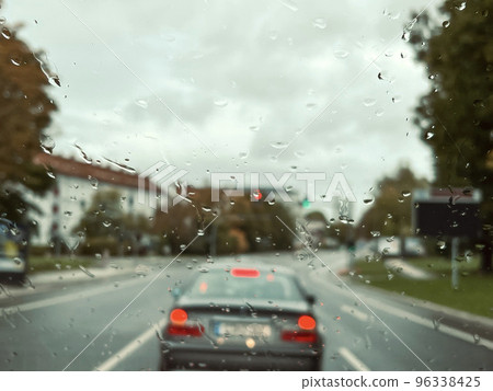 rain drops on windshield of a car in traffic rain drops on windshield of a car in traffic 96338425