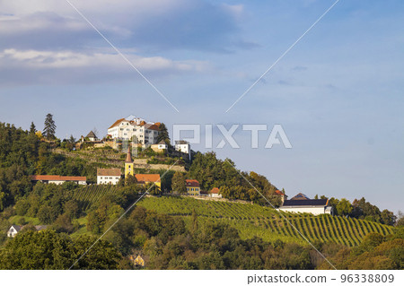 Kapfenstein castle and church with vineyard, Styria, Austria Kapfenstein castle and church with vineyard, Styria, Austria 96338809
