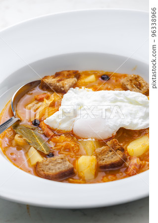 cabbage soup with poached egg 96338966