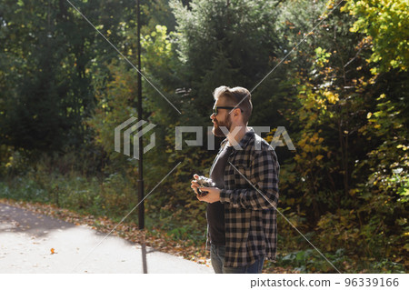 Man photographer taking picture with vintage camera on city green park copy space and place for text - leisure activity and hobby concept 96339166