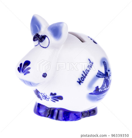 Piggy bank in a shape of a cow with blue ornament 96339350