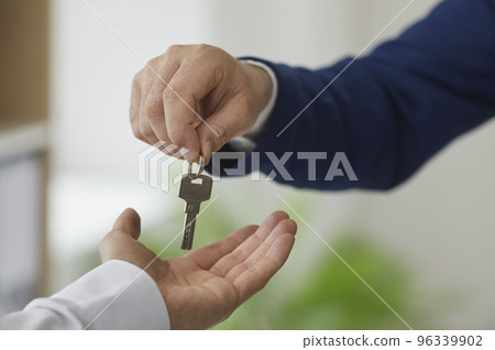 Man takes keys from real estate agent after signing lease or purchase agreement. Man takes keys from real estate agent after signing lease or purchase agreement. 96339902