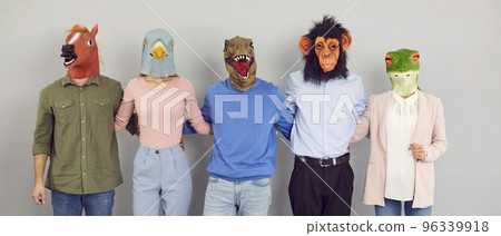 Crazy funny team of people in weird animal masks standing together and hugging each other 96339918