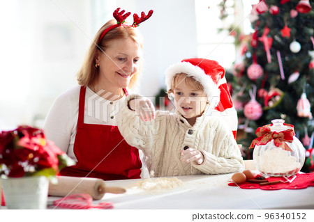 Family baking Christmas cookies. Kids Xmas fun. Family baking Christmas cookies. Kids Xmas fun. 96340152