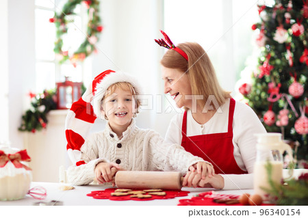 Family baking Christmas cookies. Kids Xmas fun. 96340154