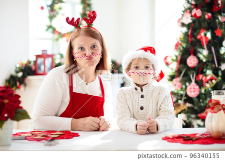 Family baking Christmas cookies. Kids Xmas fun. 96340155