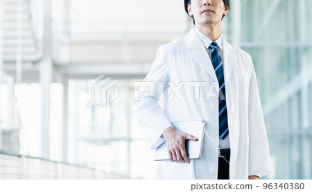 A young man wearing a white suit 96340380