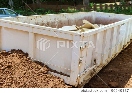 As part of construction site waste removal process metal container used for recycling garbage trash dumpster is used 96340587