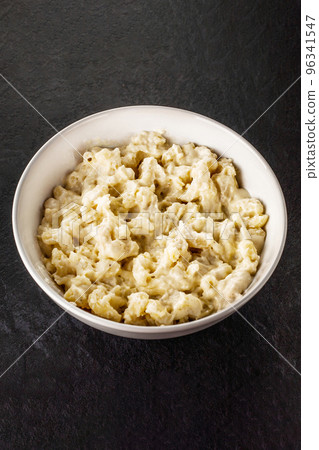 Mac and cheese. Traditional american fast food. Pasta with sauce from chedder parmesan mozarella and other cheese. 96341547