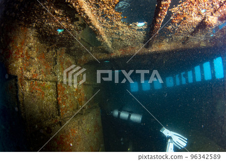 divers exploring a shipwreck underwater 96342589