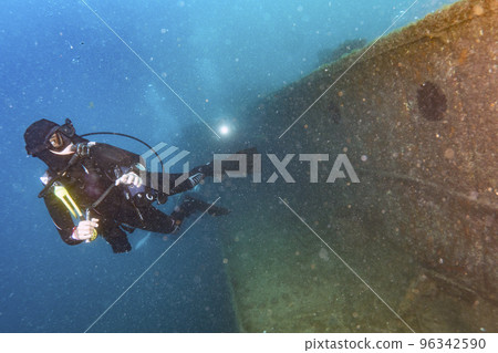 divers exploring a shipwreck underwater divers exploring a shipwreck underwater 96342590